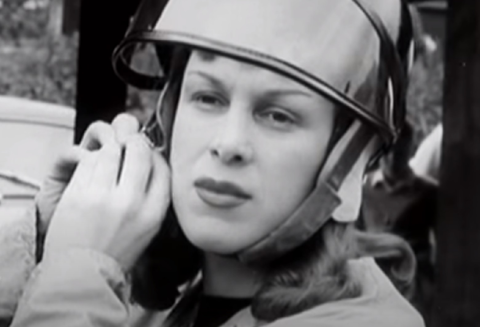 Screenshot: Roberta Cowell wearing helmet is driving a racing car - from Secret History - The Sex Change Spitfire Ace (2015)
