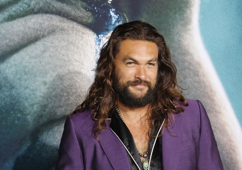 Jason Momoa at the Los TCL Chinese Theatre IMAX in Hollywood wearing purple jacket