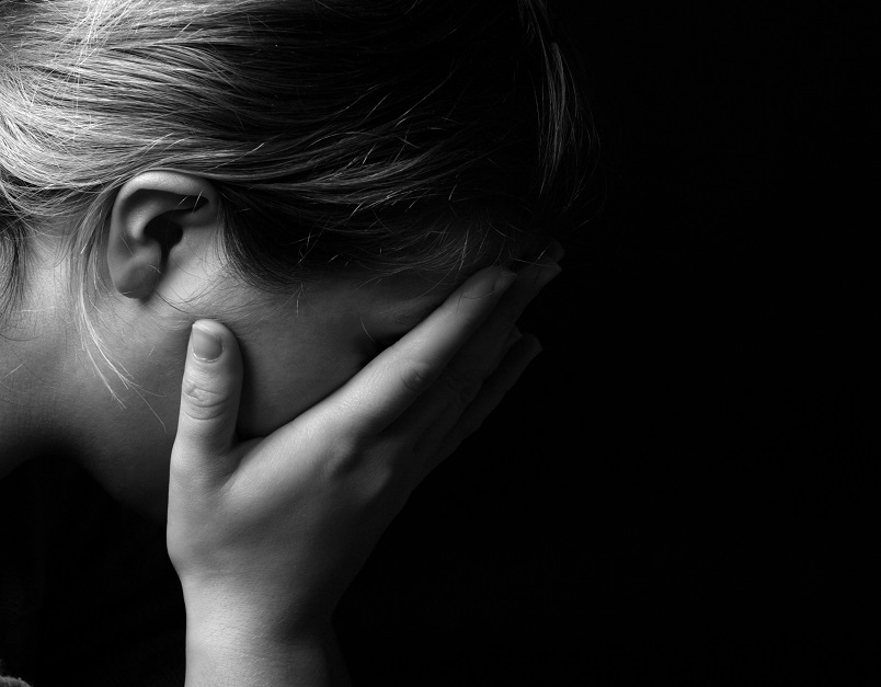 Woman crying in dark room