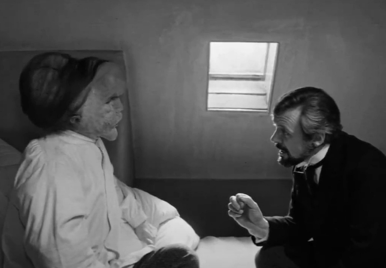 B&W Screenshot of Joseph Merrick (John Hurt) talking with Dr. Frederick Treves - from Elephant Man (1980)
