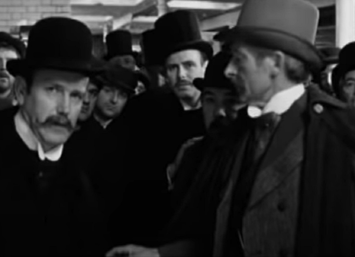 B&W Screenshot of people looking Elephant man - from Elephant Man (1980)