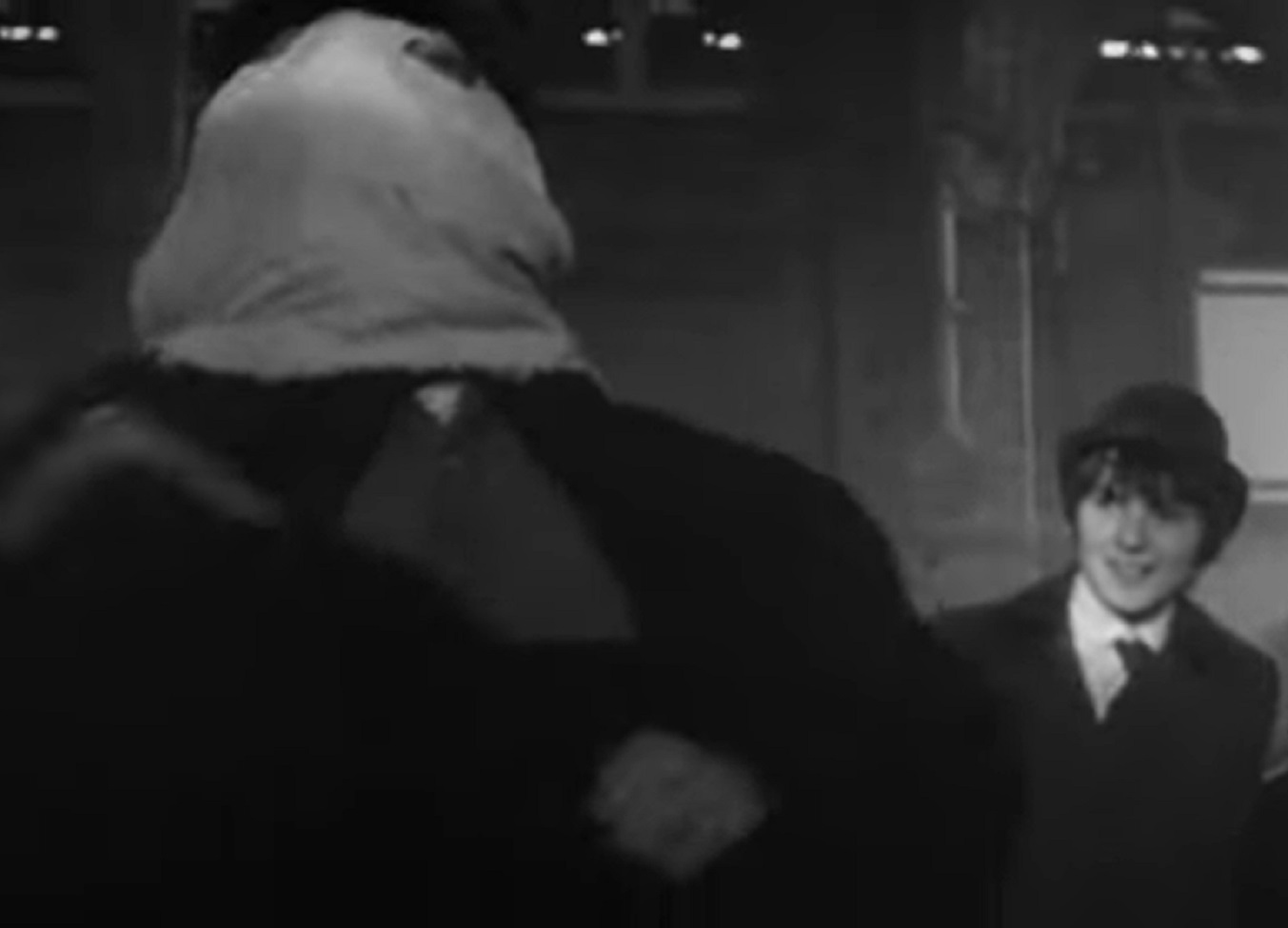 B&W Screenshot of Joseph Merrick (John Hurt) with mask walking outside - from Elephant Man (1980)