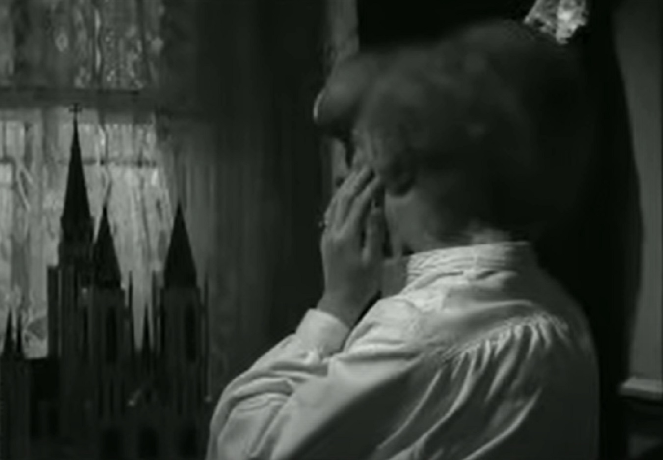 B&W Screenshot of Joseph Merrick (John Hurt) in white shirt is looking from the window - from Elephant Man (1980)