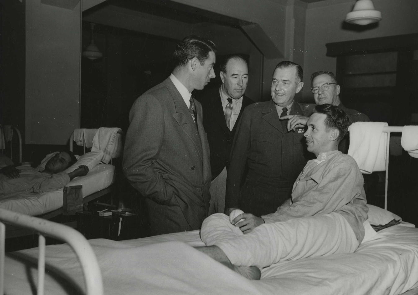 Joe DiMaggio and others stop to chat at the 155th Station Hospital