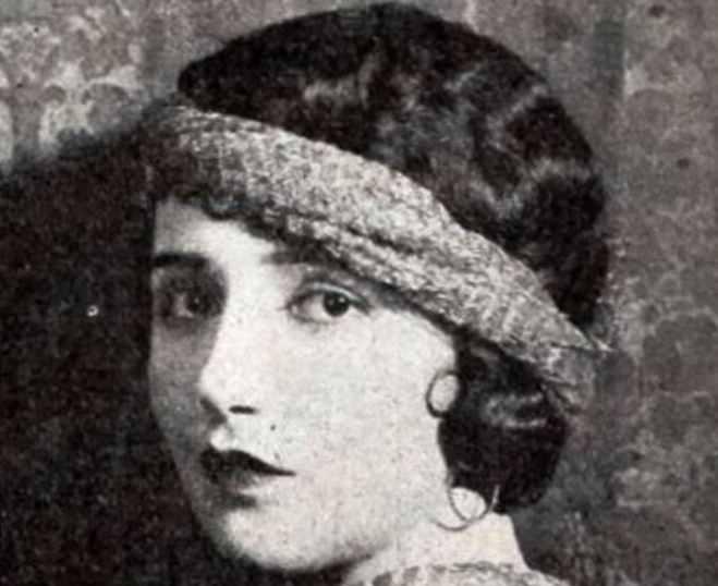 Grayscale portrait photo of the actress Babe Daniels wearing light colored dress