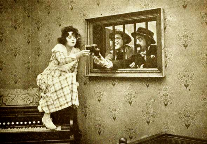 Still from the American comedy film Going! Going! Gone! (1919) with Bebe Daniels, Harold Lloyd, and Snub Pollard