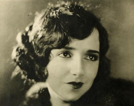 Grayscale Photo of the actress Bebe Daniels wearing a coat facing camera