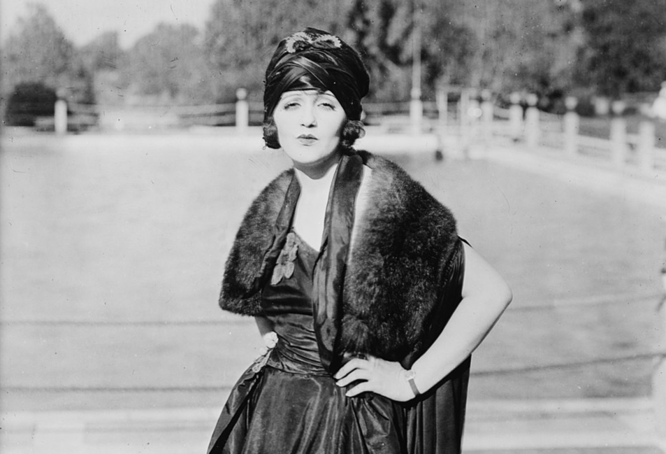Grayscale Photo of the Actress Bebe Daniels wearing a black fress and a hat