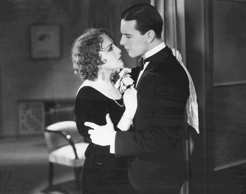 Photo from the 1930 film Alias French Gertie With Actor Ben Lyon and Actress  Bebe Daniels holding each other