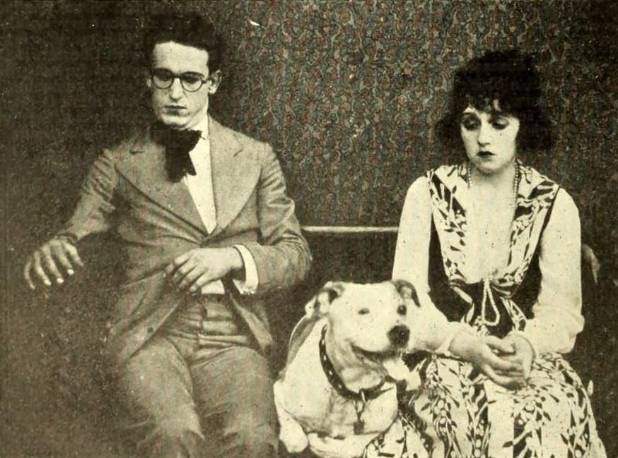 Still from the American comedy short film Ring Up the Curtain (1919) with Harold Lloyd and Bebe Daniels sitting next to each other