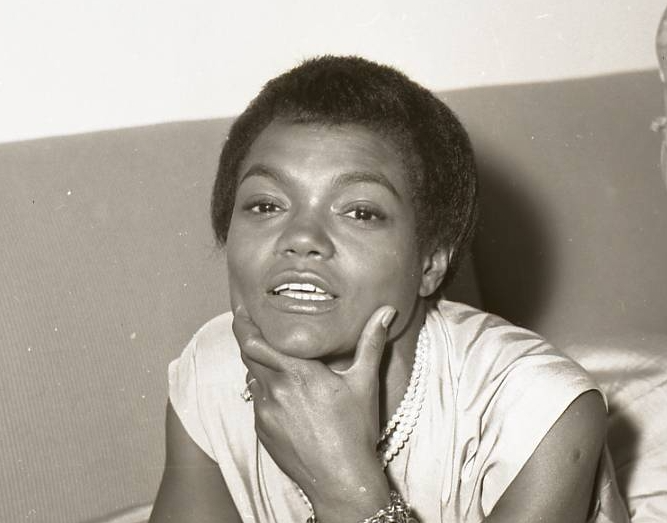 Eartha Kitt visit to Israel, wearing a white dress, lying on a bed