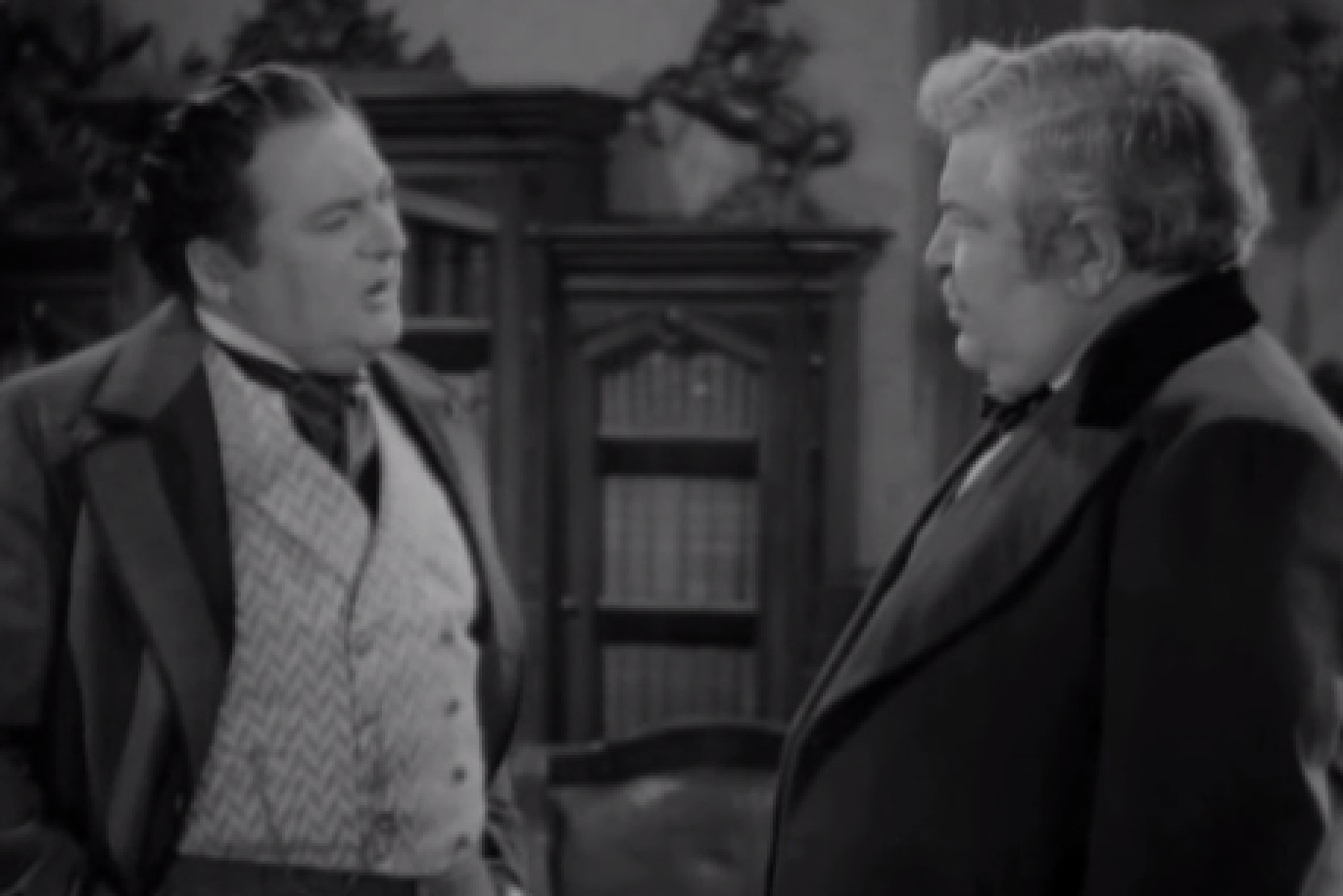 Screenshot of James Fisk (Edward Arnold) talking with other man in office - from The Toast of New York (1937)