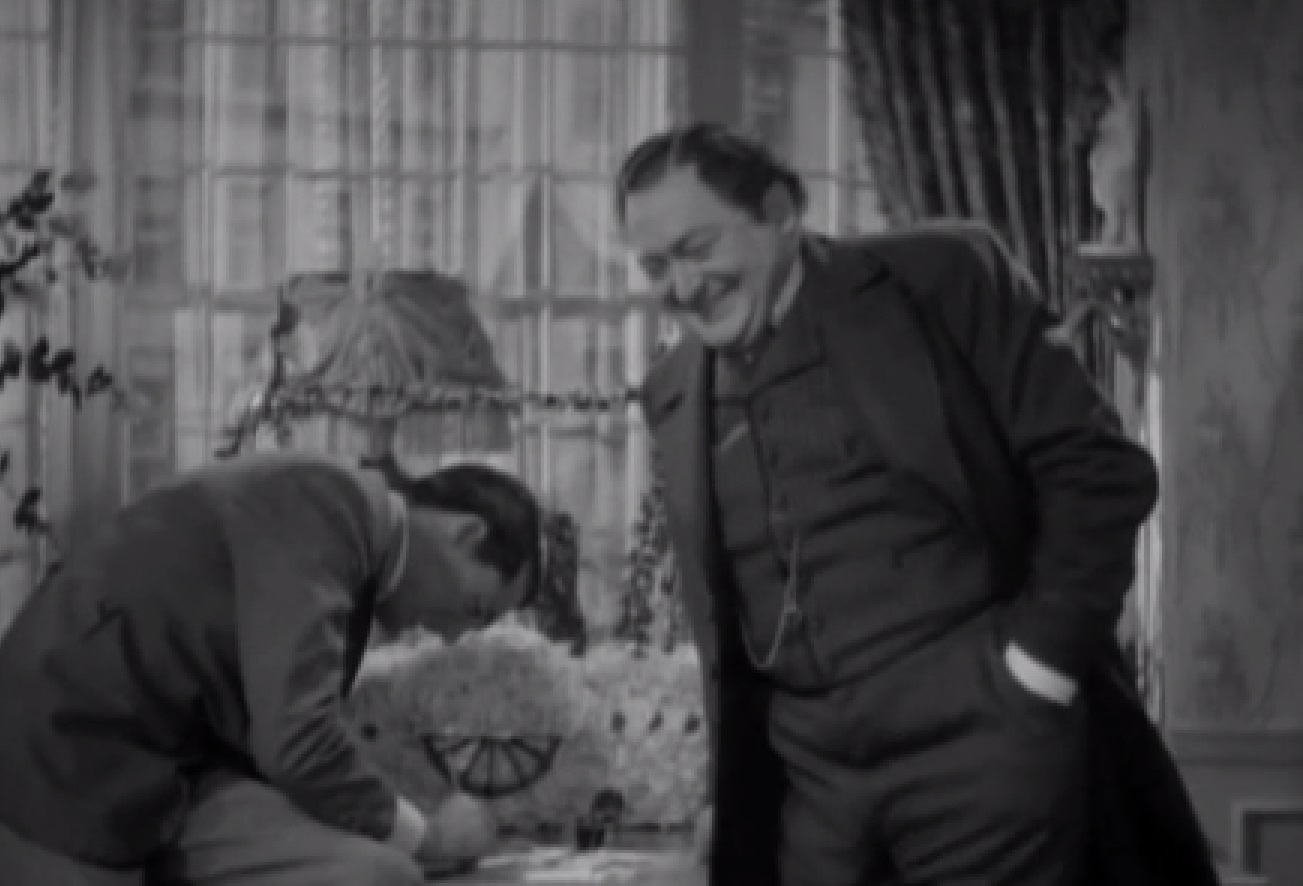 Screenshot of James Fisk (Edward Arnold) wearing suit and talking to other man - from The Toast of New York (1937)