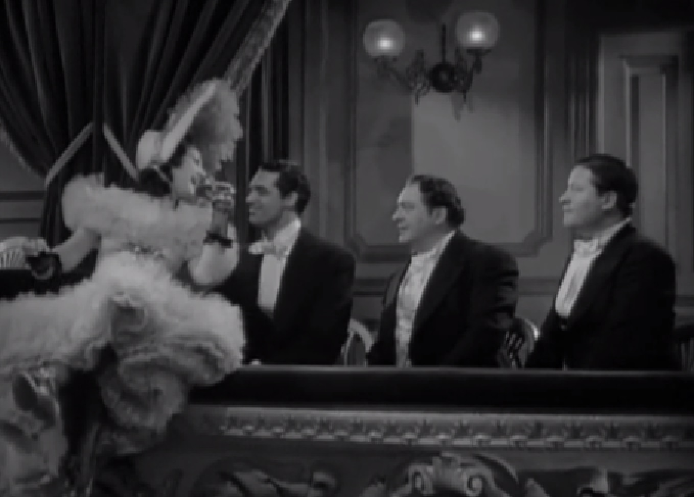 Screenshot of James Fisk (Edward Arnold) wearing suit and talking at people at party - from The Toast of New York (1937)