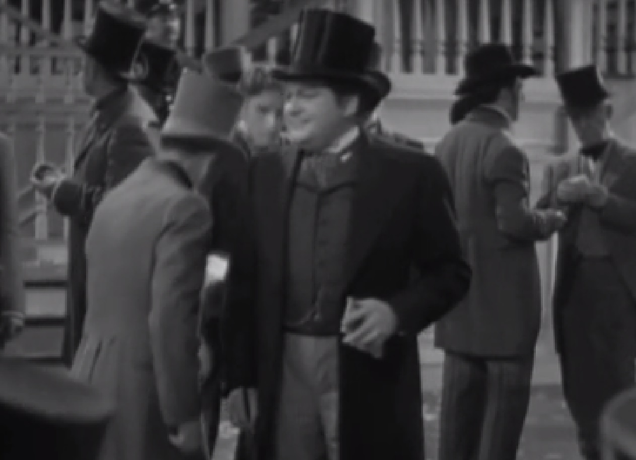 Screenshot of James Fisk (Edward Arnold) wearing suit is talking with people - from The Toast of New York (1937)