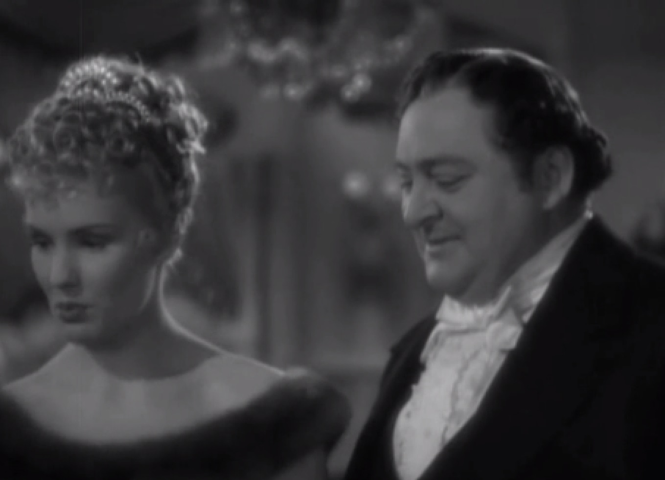 Screenshot of James Fisk (Edward Arnold) looking at Fleurique (Thelma Leeds) - from The Toast of New York (1937)
