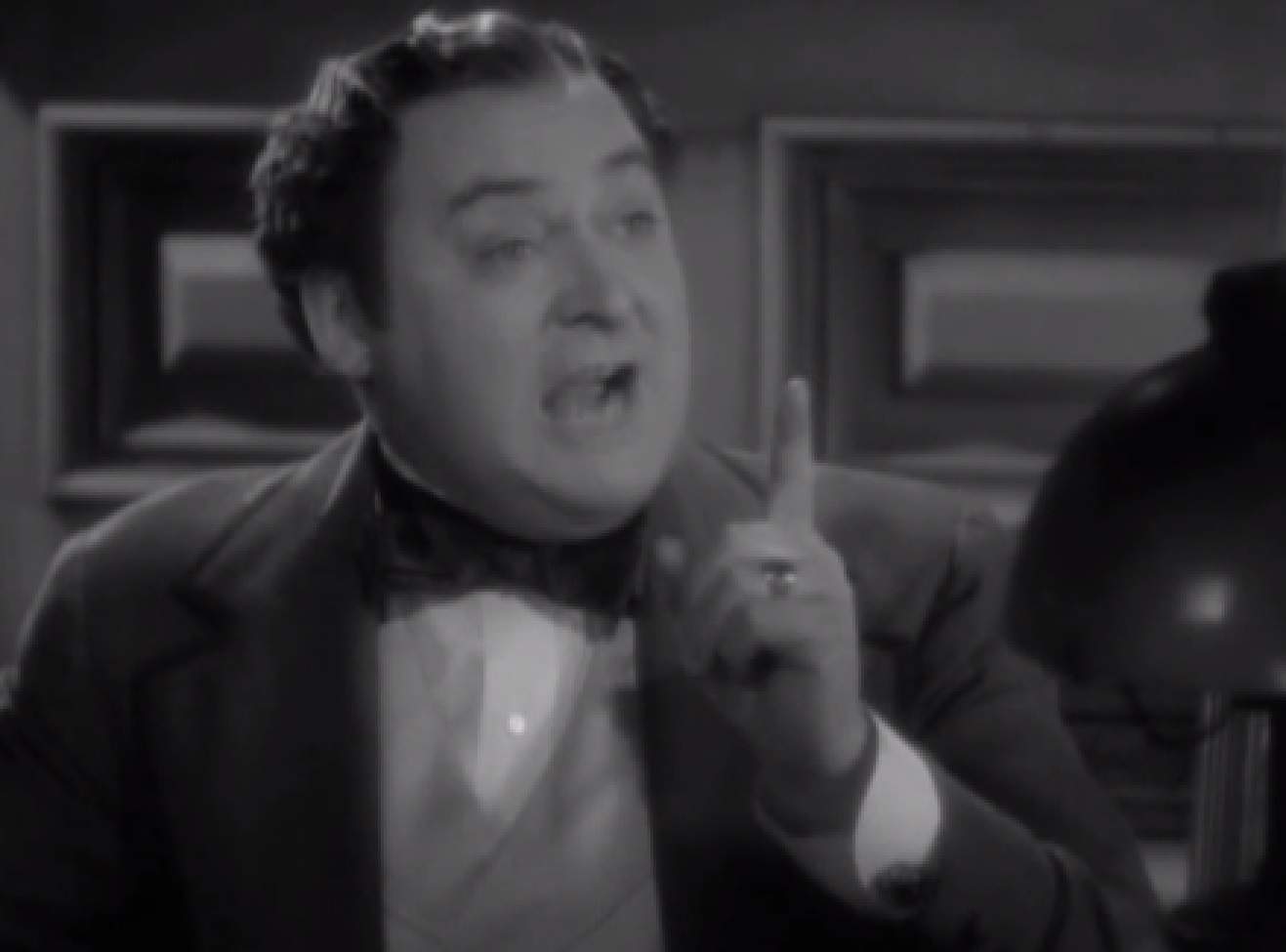 Screenshot of James Fisk (Edward Arnold) looking upset and pointing with finger - from The Toast of New York (1937)