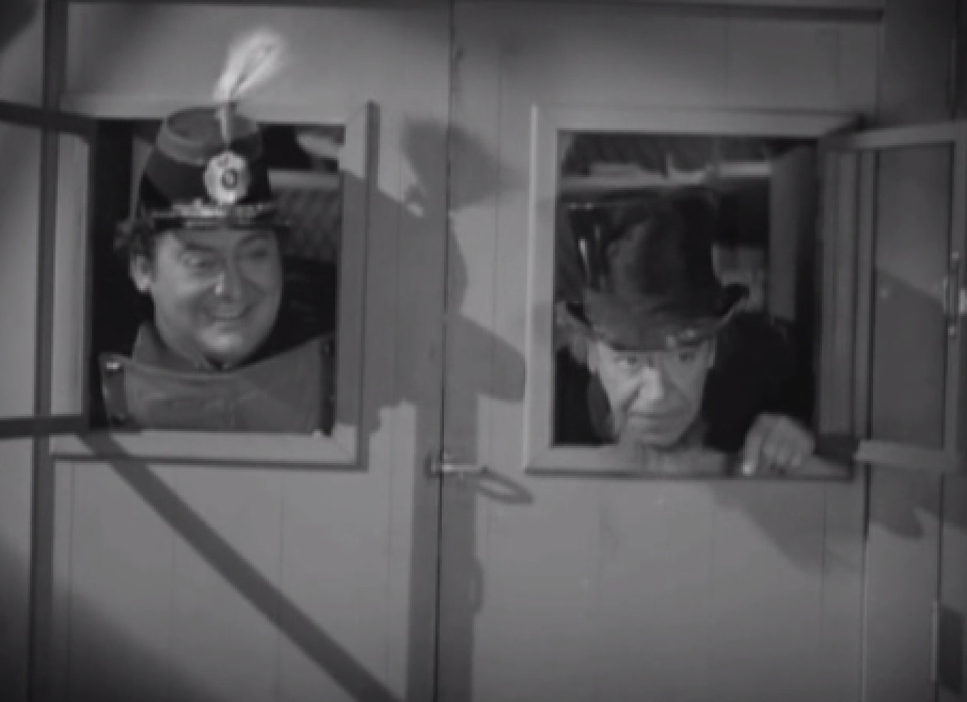 Screenshot of James Fisk (Edward Arnold) and Daniel Drew (Donald Meek) looking from windows - from The Toast of New York (1937)