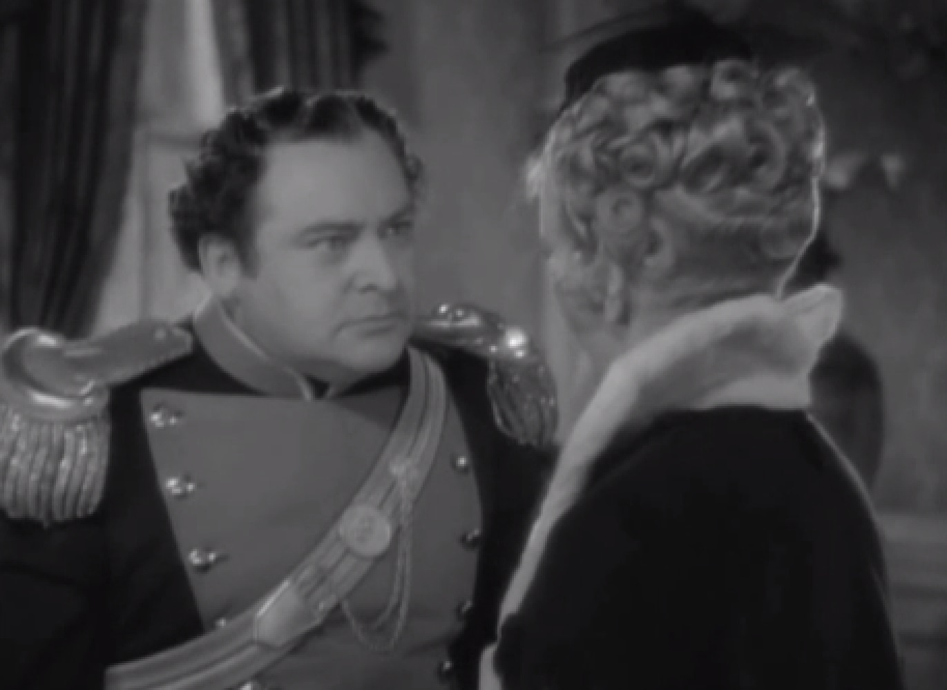 Screenshot of  James Fisk (Edward Arnold) talking to a female - from The Toast of New York (1937)