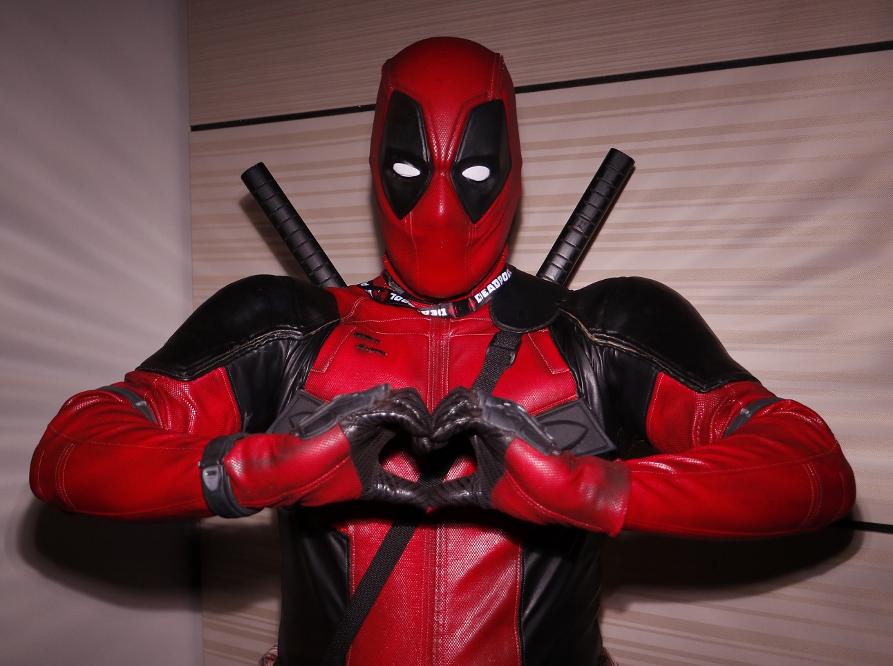 Deadpool making a heart symbol