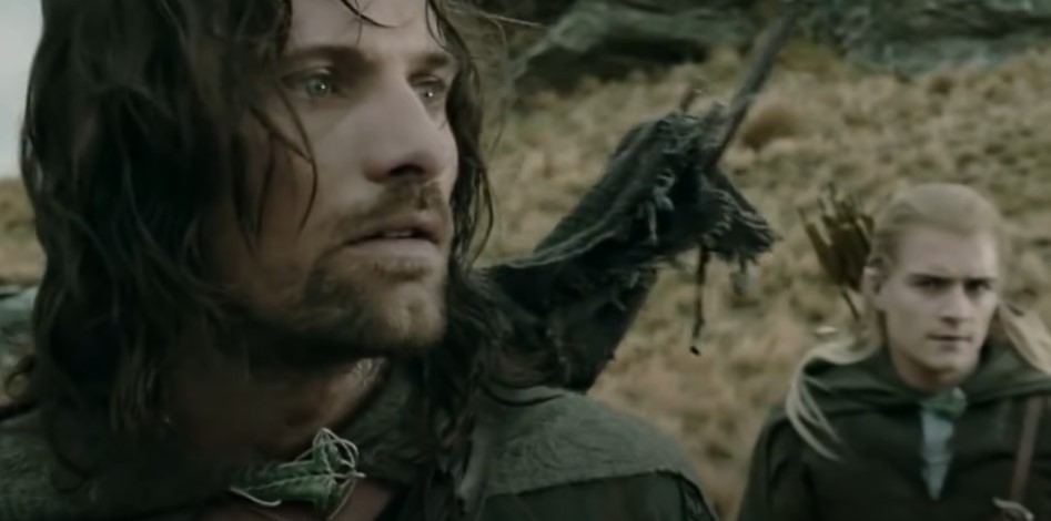 Riders of Rohan surround Aragorn, Legolas and Gimli