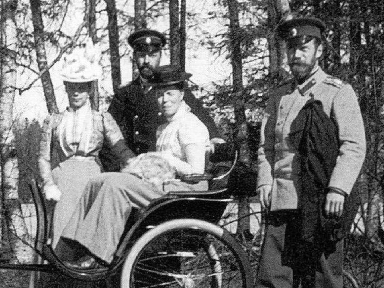 Grand Duchess Olga Alexandrovna, behind stand the Grand Duke Alexander Mikhailovich and his wife Grand Duchess Xenia Alexandrovna. - 1902
