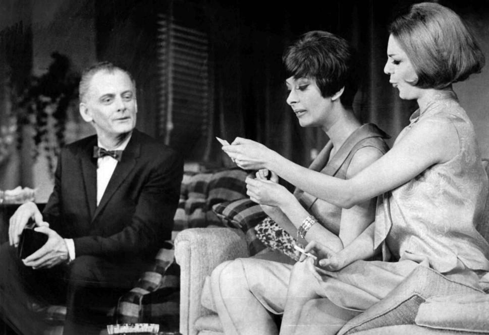 Photo of Art Carney as Felix Ungar and the Pigeon Sisters, played by Monica Evans and Carole Shelley, from the original Broadway production of The Odd Couple. - 1965