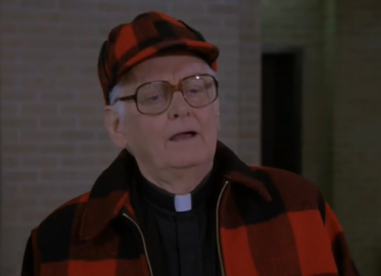 Screenshot of Art Carney wearing red shirt and hat is looking at front - from Miracle of the Heart: A Boys Town Story (1986)