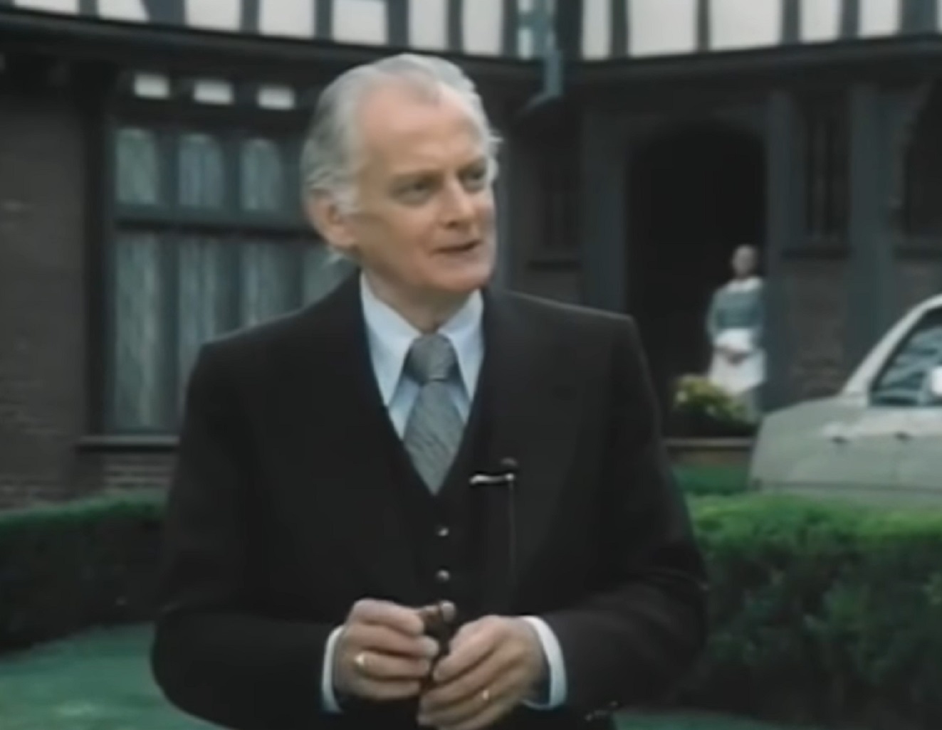 Screenshot of Art Carney wearing suit and standing outside - from Katherine (1975)