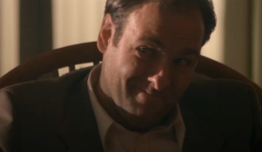 James Gandolfini as Virgil sitting at a chair