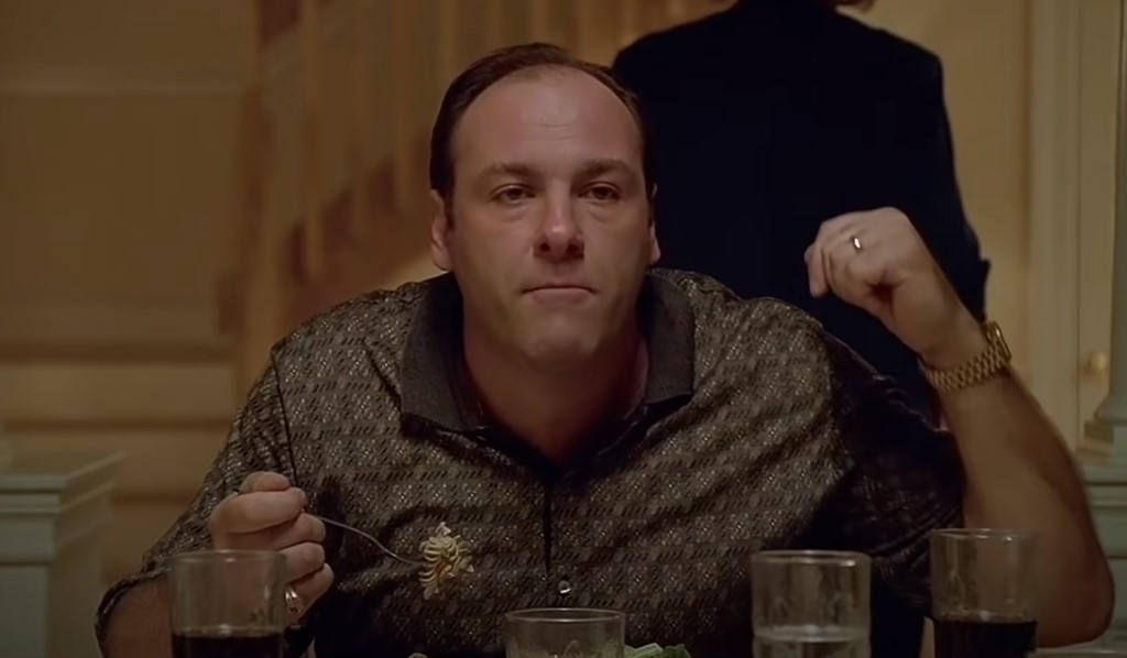 James Gandolfini as Tony Soprano sitting at a table eating