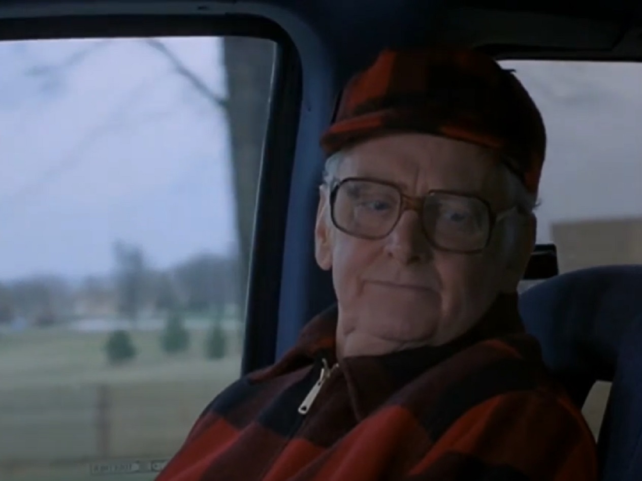 Screenshot of Art Carney wearing red shirt and red hat looking at side - from Miracle of the Heart: A Boys Town Story (1986)