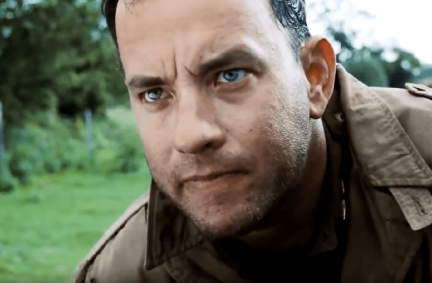 Screenshot of (Tom Hanks) Captain Miller looking upset outside - from Saving Private Ryan (1998)