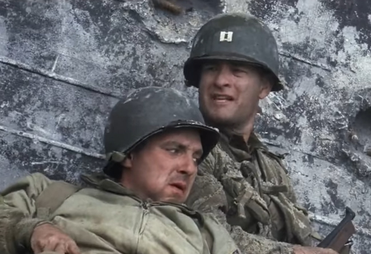 Screenshot of (Tom Hanks) Captain Miller and (Tom Sizemore) Mike Horvath hiding outside - from Saving Private Ryan (1998)