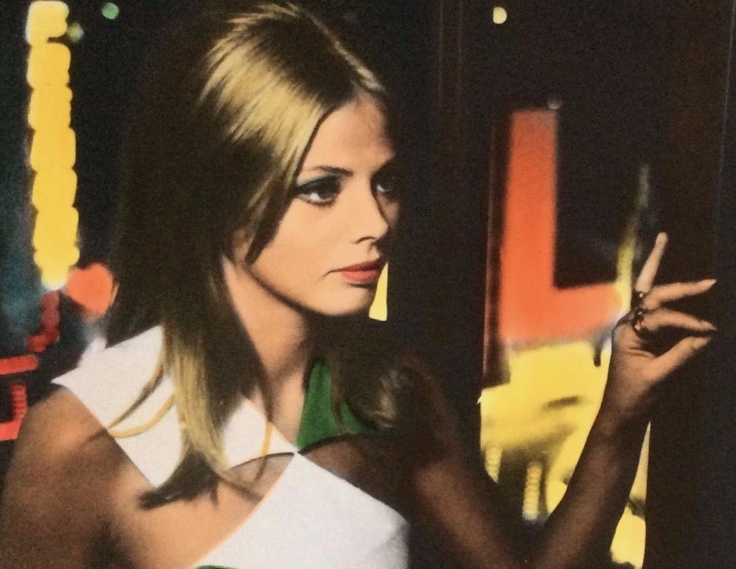 Britt Ekland posing in white top