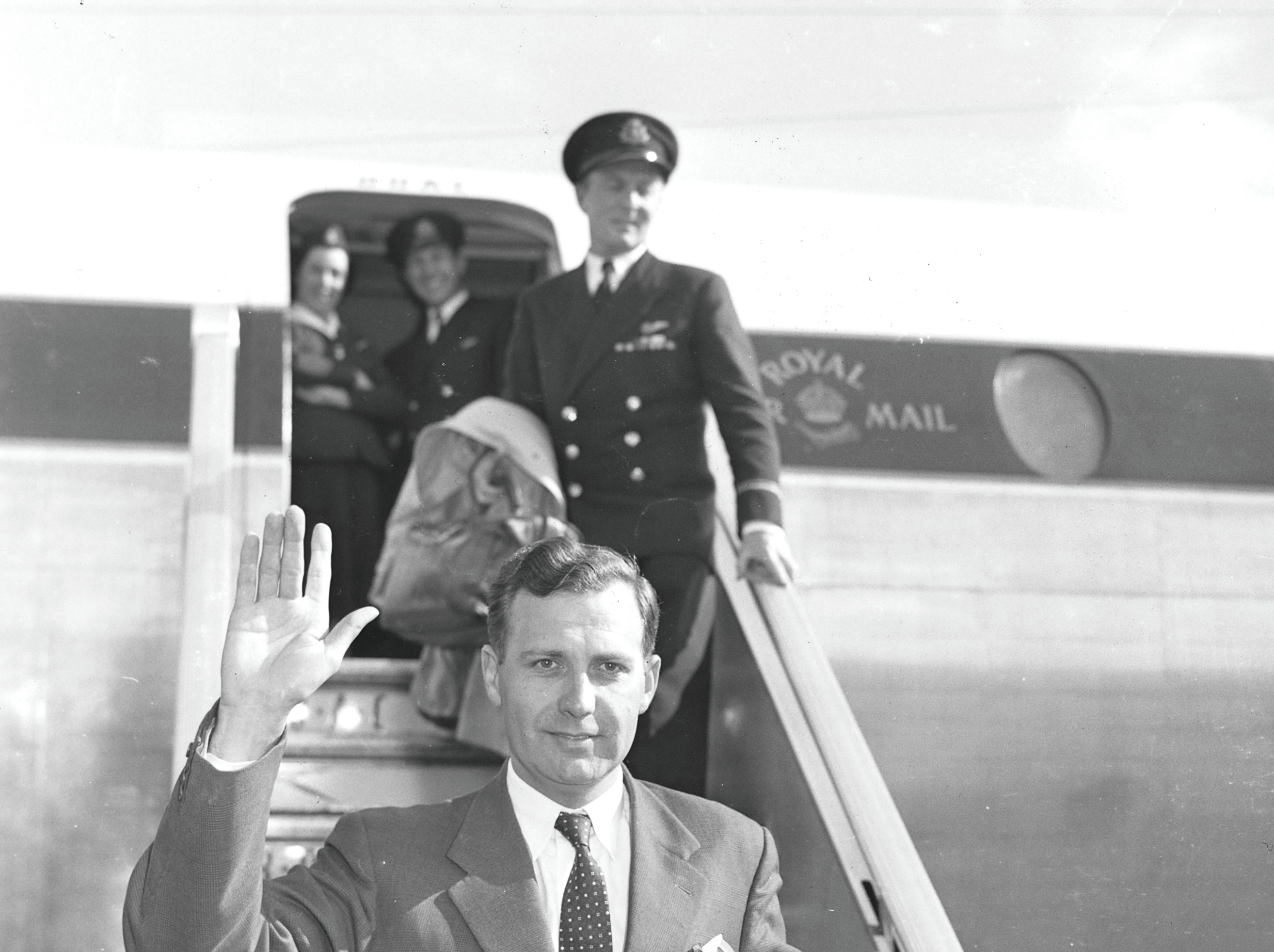 John Stonehouse (1925-1988) waves as he arrives at London Airport