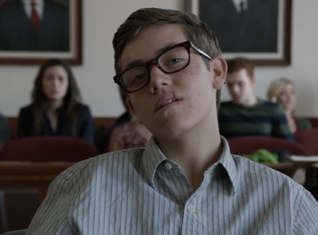 Screenshot of Carl Gallagher with glasses is looking at front - from Shameless (2011-21)