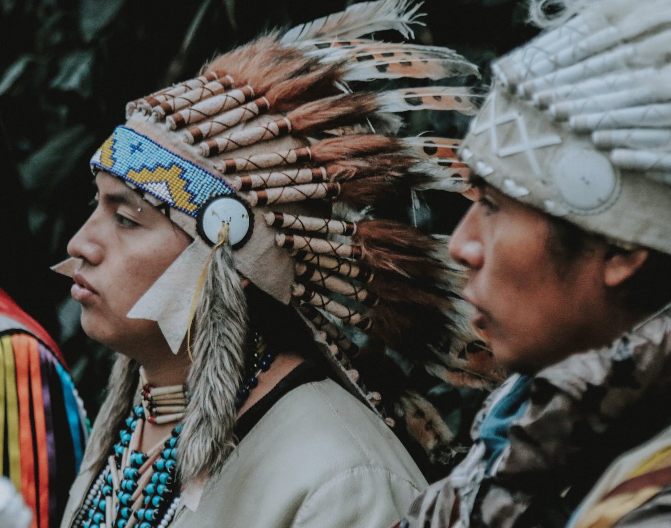 Men in traditional native American clothes.