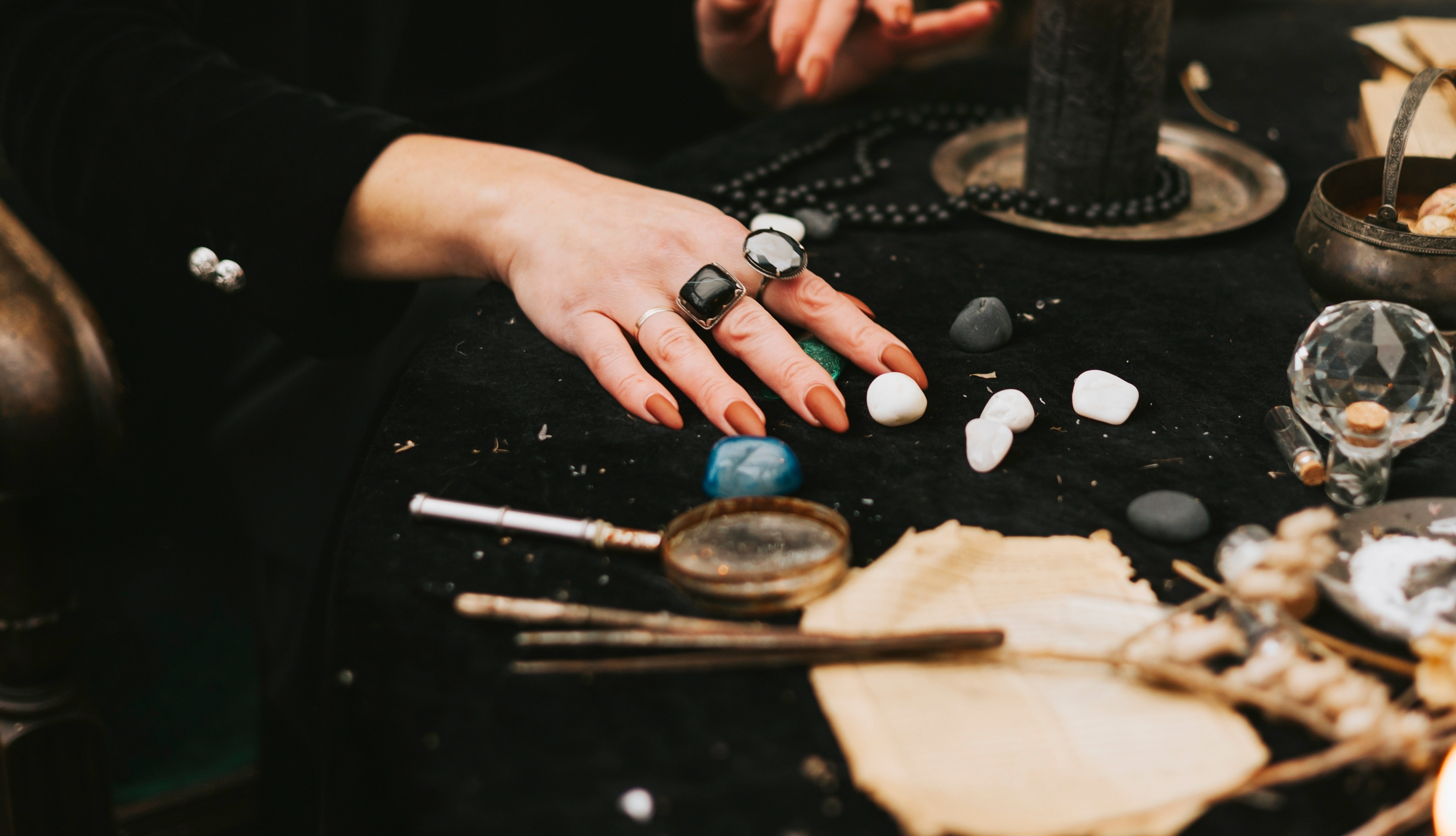 woman in black hat and witch outfit does magic