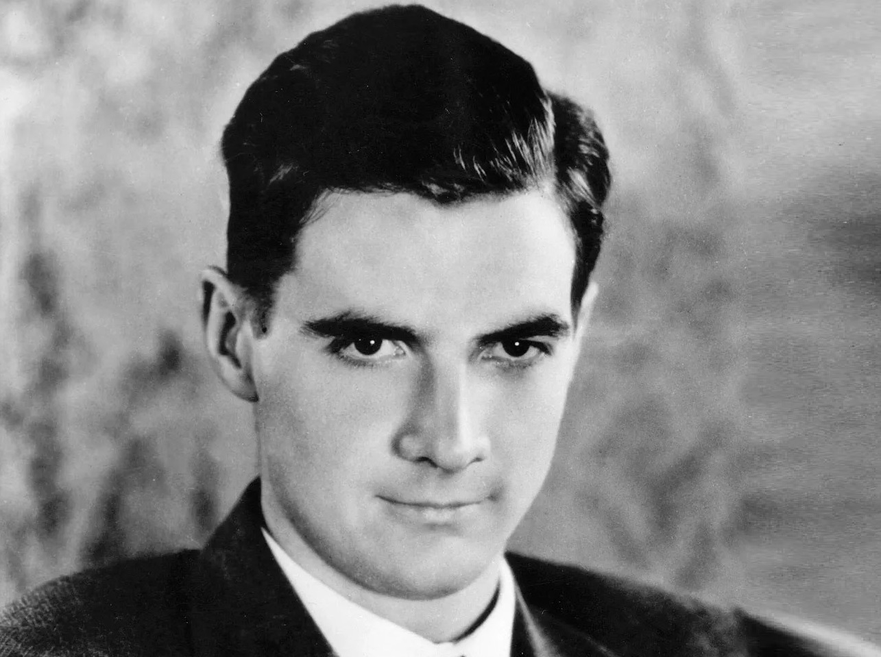 Portrait of Howard Hughes wearing black suit looking down - 1938