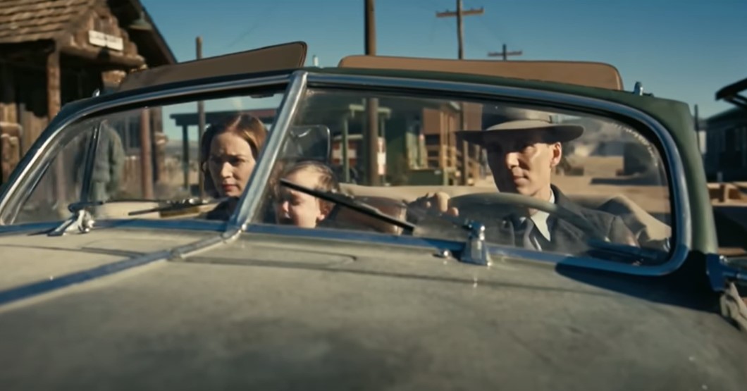 Cillian Murphy as Robert Oppenheimer wearing suit and hat and his family