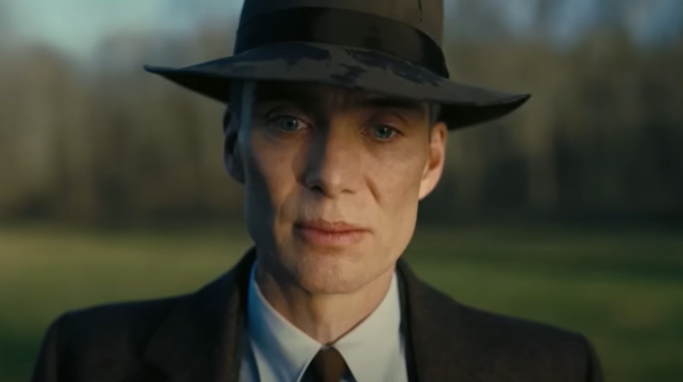 Cillian Murphy as Robert Oppenheimer in older age wearing suit and hat