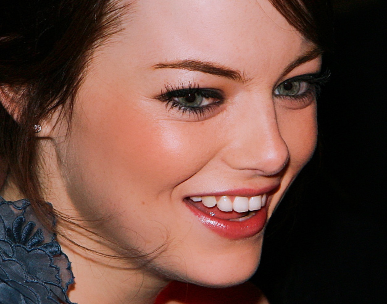 Emma Stone looking a side and smiling - 2010