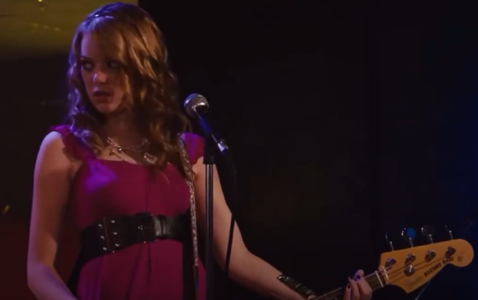Screenshot: Emma Stone playing guitar on the stage - from The Rocker 2008