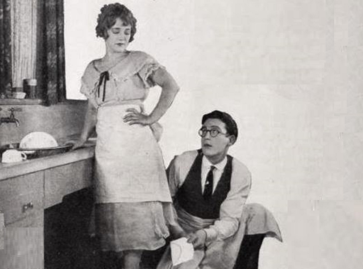 Mildred Davis and Harold Lloyd looking at each other at kitchen - from film I Do (1921)