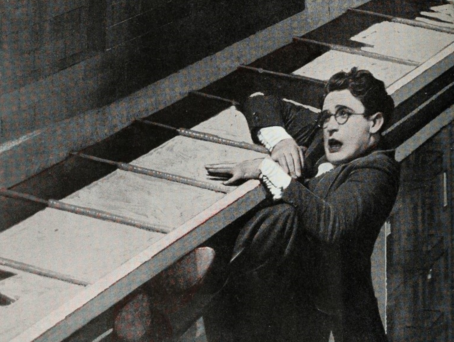 Harold Lloyd hanging from a side in advertisement for the American comedy film Safety Last! - 1923