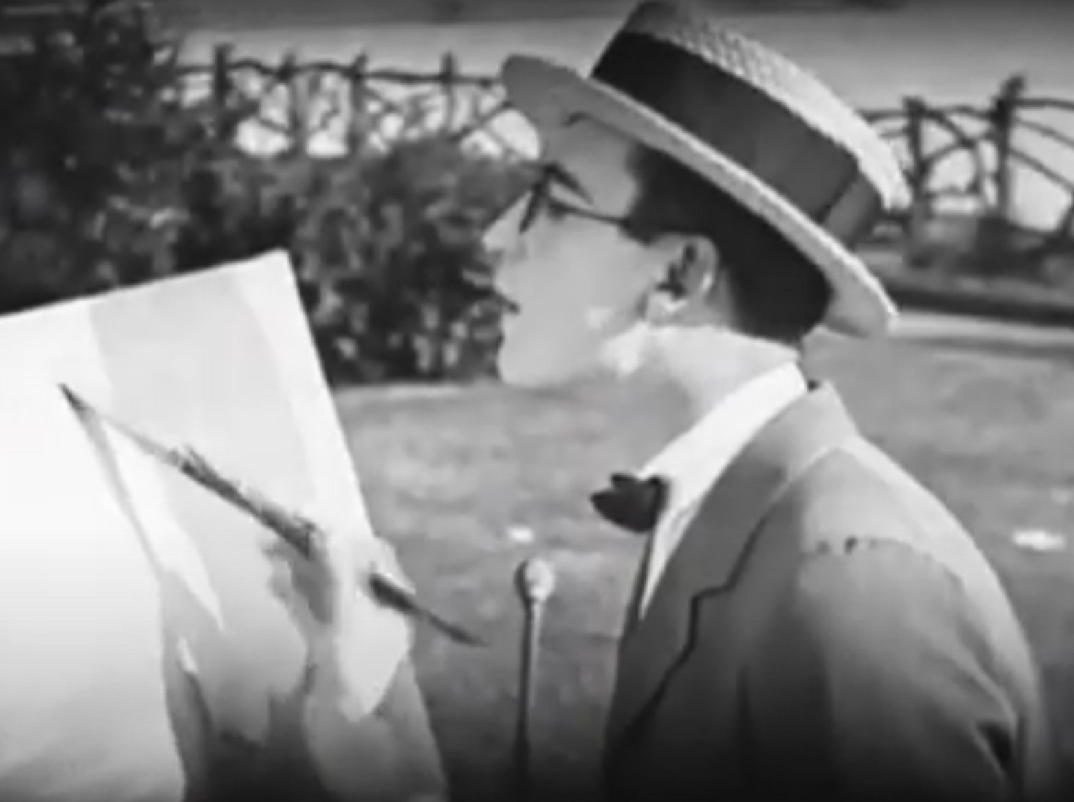 Screenshot B&W - Harold Lloyd painting on the canvas outside  - from A Sailor-Made Man (1921)