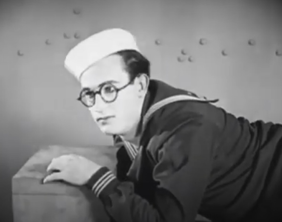 Screenshot B&W - Harold Lloyd wearing navy uniform and white hat laying at side - from A Sailor-Made Man (1921)