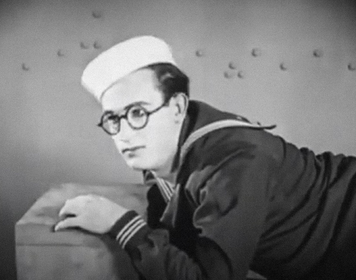 Screenshot B&W - Harold Lloyd Wearing a navy suit with white hat and smiling - From A Sailor-Made Man (1921)