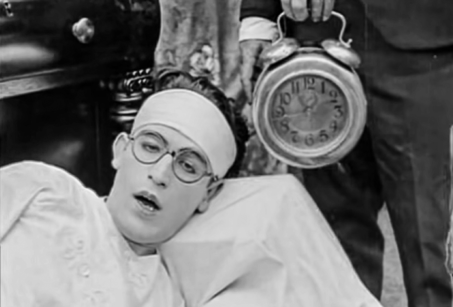 Screenshot B&W - Harold Lloyd wearing white shirt ,looking sleepy -from Captain Kidd's Kids (1919)